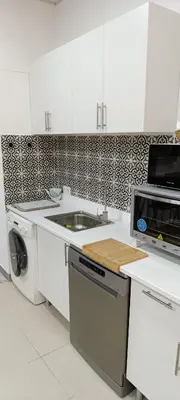 a living room with a large television on a wall at apartamentos el circulo mágico in Arcos de la Frontera
