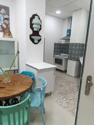 a white kitchen with a sink and a microwave at apartamentos el circulo mágico in Arcos de la Frontera