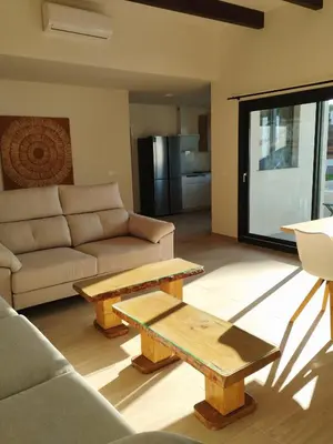 a living room with a couch and a coffee table at villa woody playa in Chiclana de la Frontera