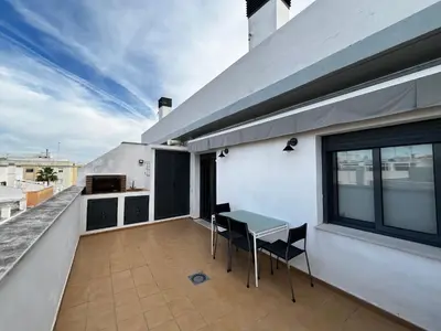a balcony with a table and chairs on a building at Penthouse San Felix Grupo AC Gestion in Cádiz
