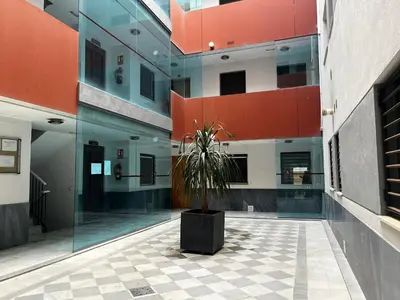a potted plant in a courtyard of a building at Penthouse San Felix Grupo AC Gestion in Cádiz