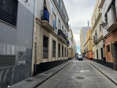 an empty street in a city with buildings at Penthouse San Felix Grupo AC Gestion in Cádiz