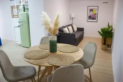 a living room with a table with chairs and a couch at Centro Villamarta Moderno in Jerez de la Frontera