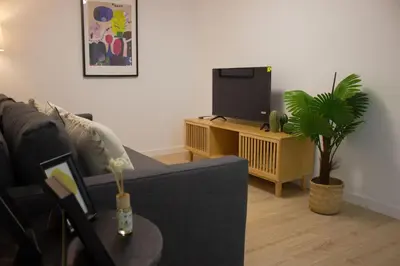 a living room with a couch and a tv at Centro Villamarta Moderno in Jerez de la Frontera