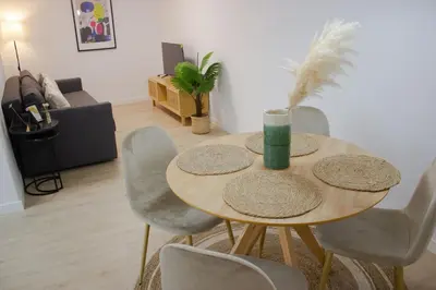 a dining room table with chairs and a table at Centro Villamarta Moderno in Jerez de la Frontera