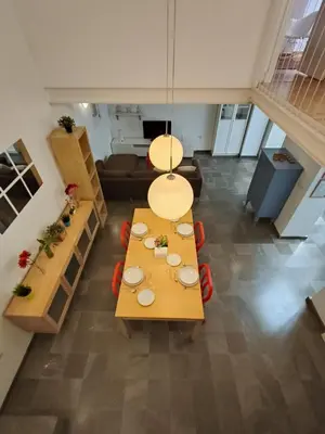 a living room with a table and a couch at Robles-Mercado in Cádiz
