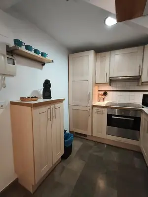 a kitchen with white cabinets and a stove top oven at Robles-Mercado in Cádiz
