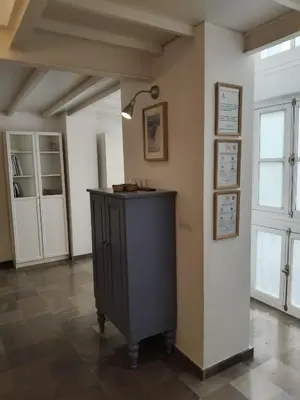 a room with a table with a lamp on a wall at Robles-Mercado in Cádiz