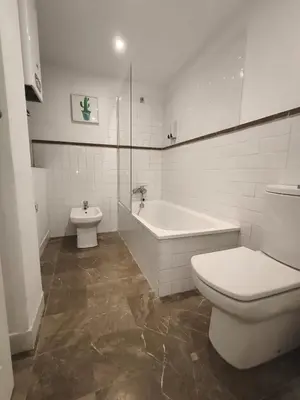 a bathroom with a toilet and a tub and a sink at Robles-Mercado in Cádiz