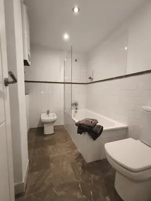 a bathroom with a toilet and a tub and a sink at Robles-Mercado in Cádiz