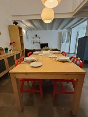 a wooden table with plates and wine glasses on it at Robles-Mercado in Cádiz
