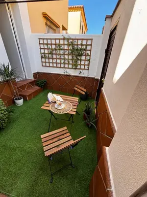 a patio with a table and bench on a balcony at Aires de Sanlúcar in Sanlúcar de Barrameda