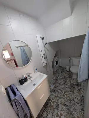 a bathroom with a sink and a mirror and a toilet at Aires de Sanlúcar in Sanlúcar de Barrameda