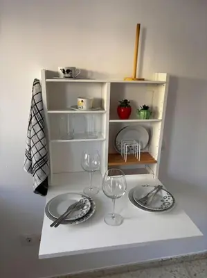 a miniature kitchen with two plates and wine glasses at Aires de Sanlúcar in Sanlúcar de Barrameda