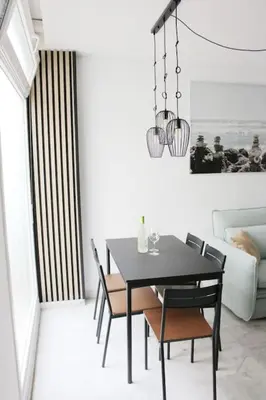 a dining room with a black table and chairs at Coqueto encantador en el centro in El Puerto de Santa María