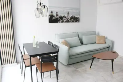 a living room with a couch and a table at Coqueto encantador en el centro in El Puerto de Santa María