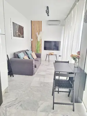 a living room with a couch and a table at Original y Coqueto en el Centro in El Puerto de Santa María