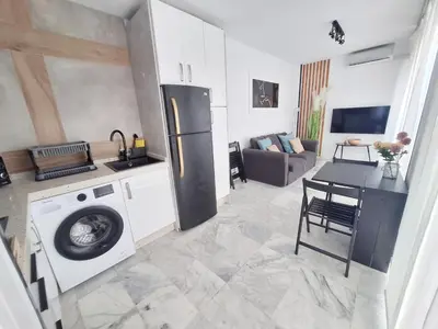 a kitchen with a refrigerator and a washing machine at Original y Coqueto en el Centro in El Puerto de Santa María