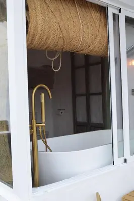 a bathroom with a sink and a tub in a window at Laan Arcos, casa cueva in Arcos de la Frontera