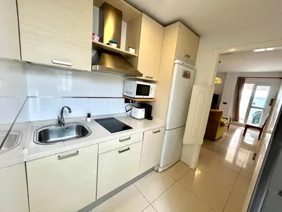 a white kitchen with a sink and a microwave at GATU Faro con Parking gratis, 