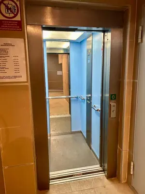 an elevatorexit in a building with a glass door at GATU Faro con Parking gratis, 