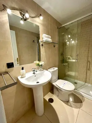 a bathroom with a sink and a toilet and a shower at GATU Faro con Parking gratis, 