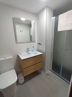 a bathroom with a toilet and a sink and a shower at Doña Cora in San Fernando