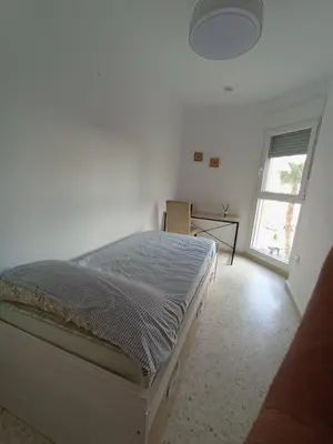 a bedroom with a bed in a room with a window at Doña Cora in San Fernando