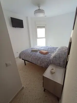 a small bedroom with a bed and a window at Doña Cora in San Fernando