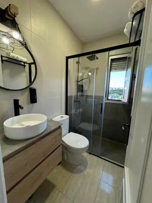 a bathroom with a toilet and a sink and a shower at Apartamentos Modern Homes in Chiclana de la Frontera