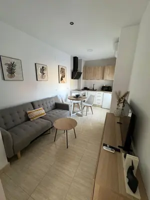 a living room with a couch and a table at Apartamentos Modern Homes in Chiclana de la Frontera