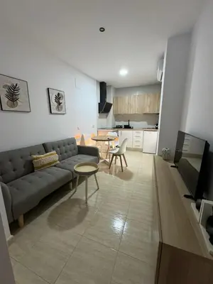a living room with a couch and a table at Apartamentos Modern Homes in Chiclana de la Frontera