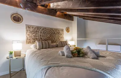 a bedroom with a large white bed with pillows at Alcazar Centrico Moderno in Jerez de la Frontera
