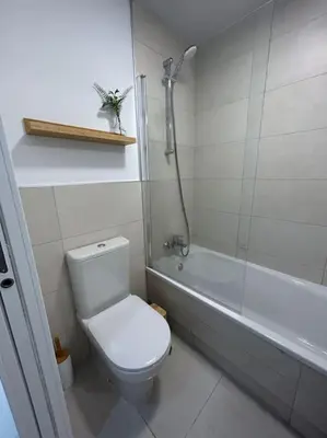 a bathroom with a toilet and a bath tub at Apartamento en Costa Ballena in Chipiona