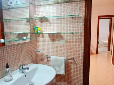 a bathroom with a sink and a mirror at Tempul Garden Suite in Jerez de la Frontera