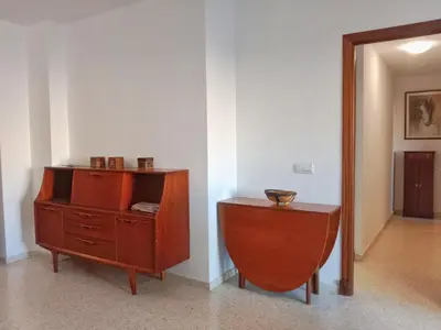 a wooden dresser and a table in a room at Tempul Garden Suite in Jerez de la Frontera