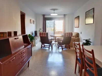 a living room with a dining room table and chairs at Tempul Garden Suite in Jerez de la Frontera