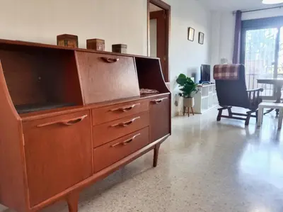 a large wooden dresser in a living room at Tempul Garden Suite in Jerez de la Frontera