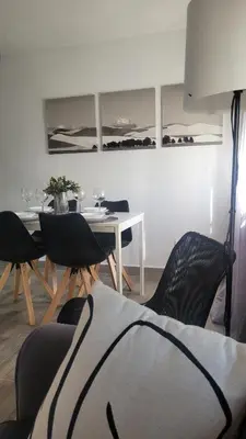 a dining room with a table and chairs and a table at Apartamento Viñedos de Librado in Jerez de la Frontera