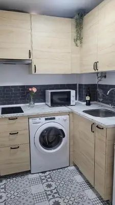 a kitchen with a washing machine and a sink at Apartamento Viñedos de Librado in Jerez de la Frontera