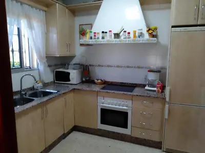 a small kitchen with a sink and a microwave at Casa La Laguneta in Arcos de la Frontera