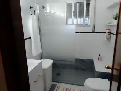 a white bathroom with a sink and a toilet at Casa La Laguneta in Arcos de la Frontera