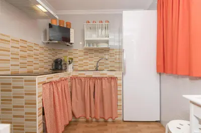 a kitchen with a sink and a shower curtain at Jopamar in Chiclana de la Frontera