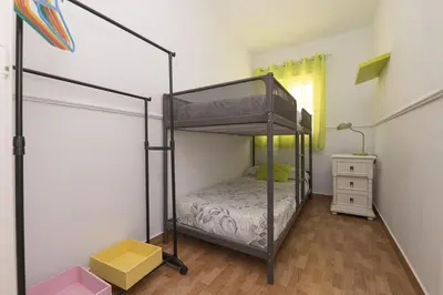 a bedroom with a bunk bed in a room at Jopamar in Chiclana de la Frontera