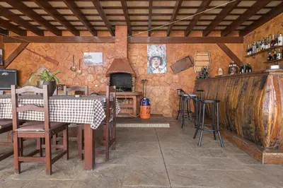a dining room with a table and chairs and a fireplace at Jopamar in Chiclana de la Frontera