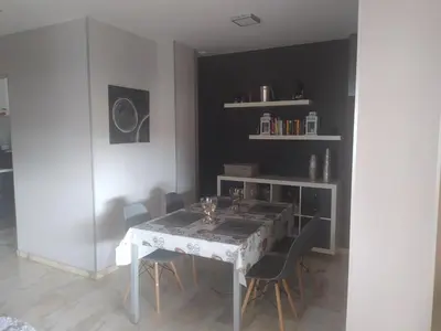 a dining room with a white table and chairs at Áprtamento novo Santi Petri in Chiclana de la Frontera