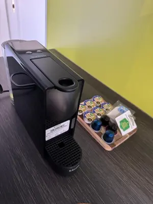 a black printer sitting on a counter with a tray of cupcakes at Mobil Home La Barrosa in Chiclana de la Frontera