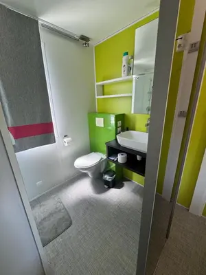 a bathroom with a toilet and a sink at Mobil Home La Barrosa in Chiclana de la Frontera