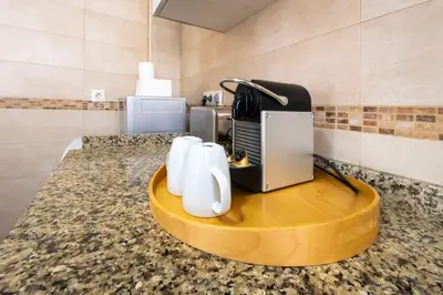 a kitchen counter with a coffee maker on a table at Cadizz-Ático El Falla con terraza de 40m2 in Cádiz