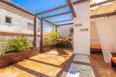 a balcony with plants and a wooden floor at Cadizz-Ático El Falla con terraza de 40m2 in Cádiz